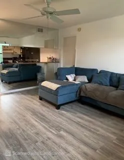 Open-concept living space with wood-finish flooring
