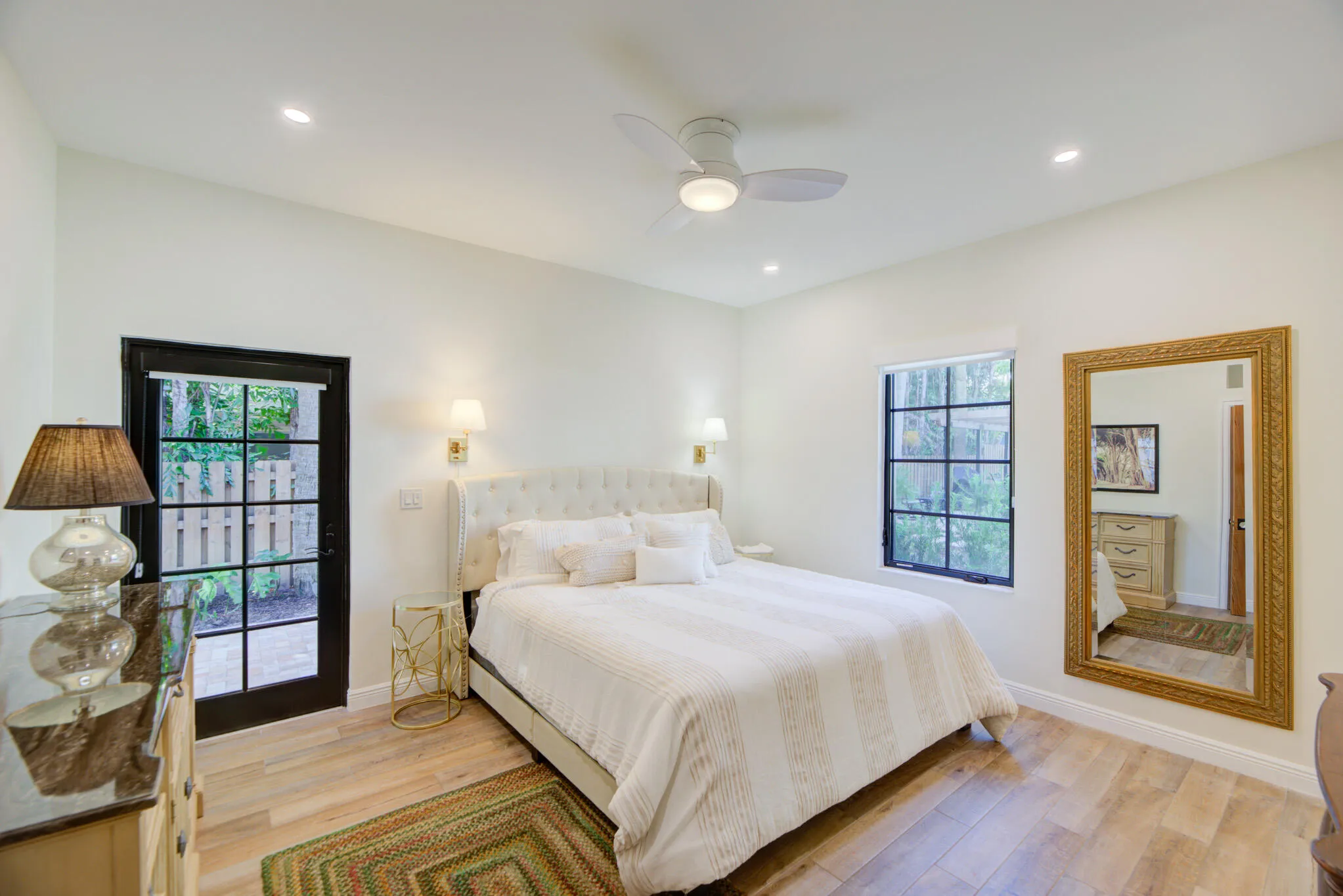 Light wood-finish flooring with white walls and a vaulted ceiling