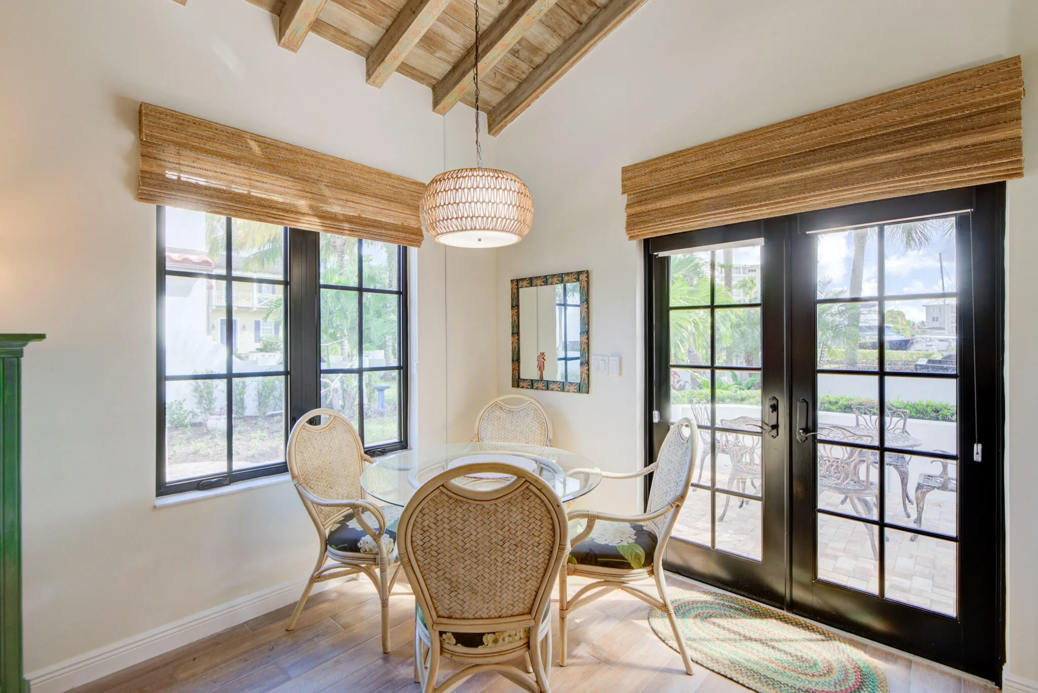 Vaulted wood-beamed ceiling with a woven pendant light fixture