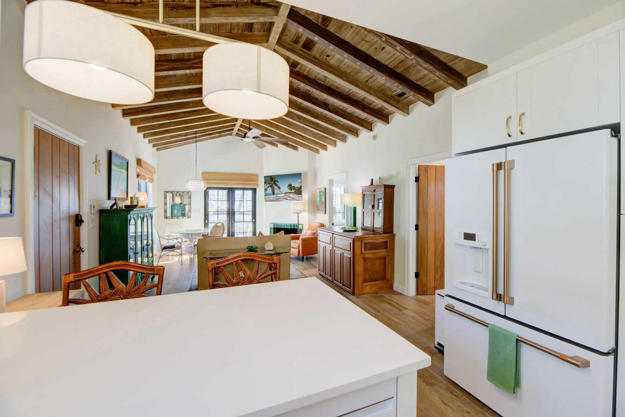 Vaulted wood-beamed ceilings create an open atmosphere, complemented by wood-finish flooring