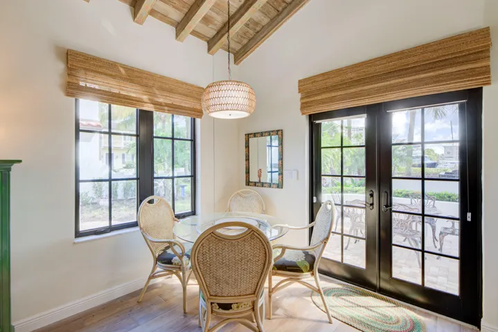 Vaulted wood-beamed ceiling with a woven pendant light fixture