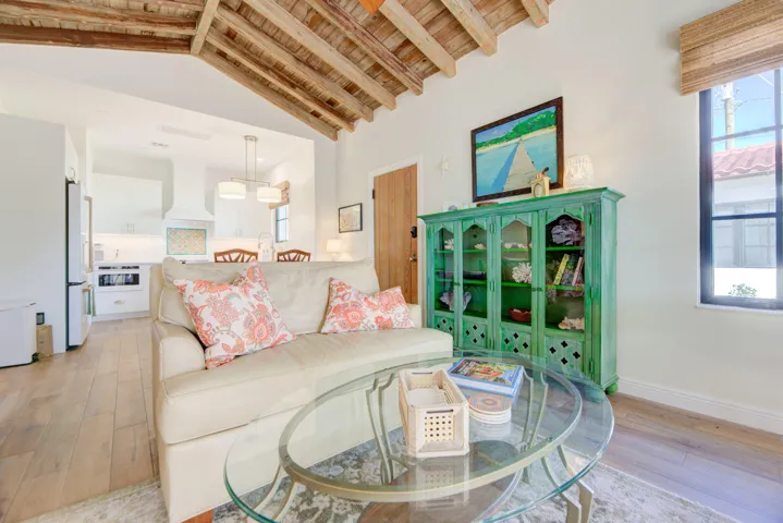 Vaulted wood-beam ceiling over a living area with wood-finish flooring