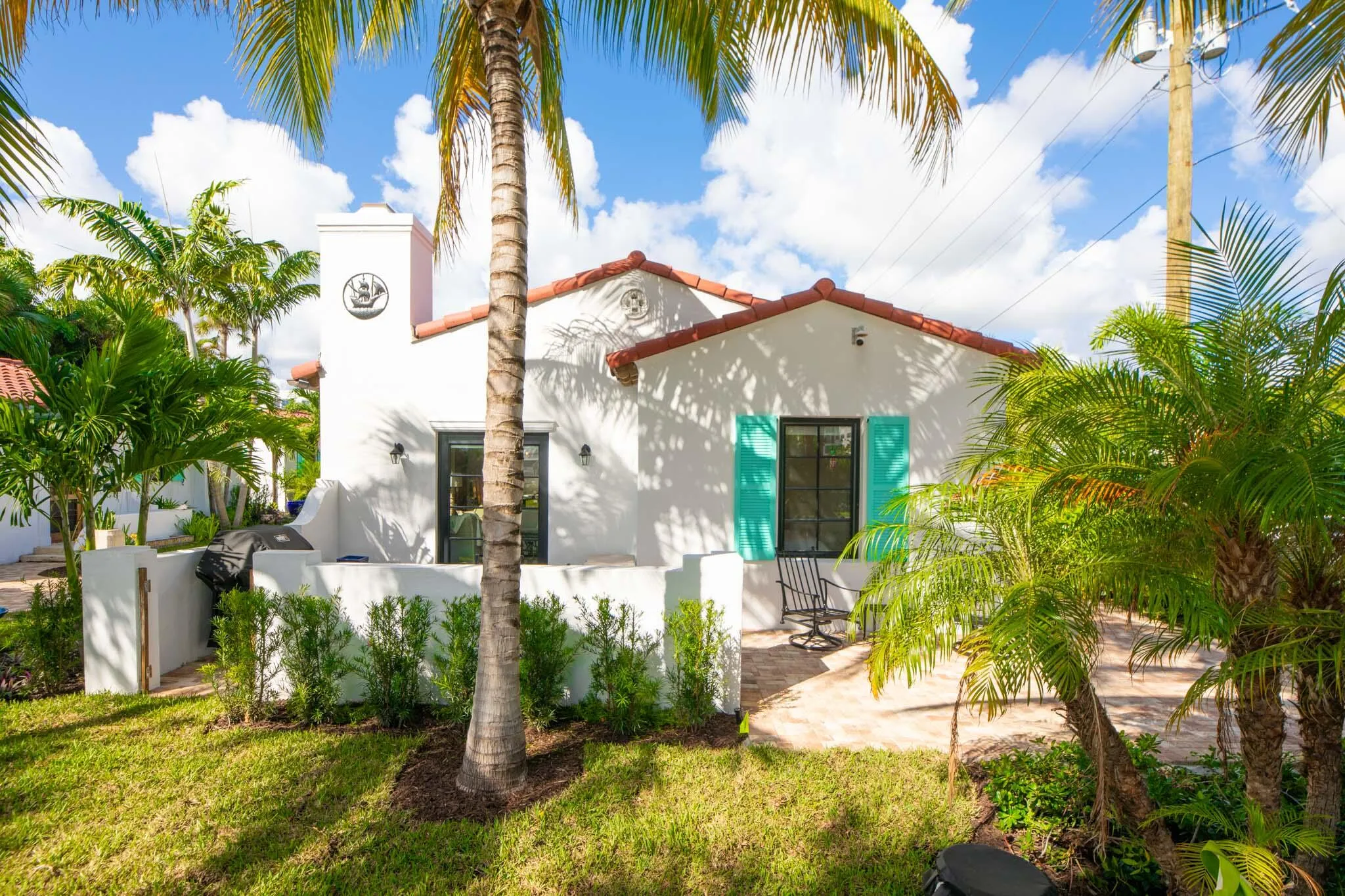 White stucco exterior with a red barrel tile roof