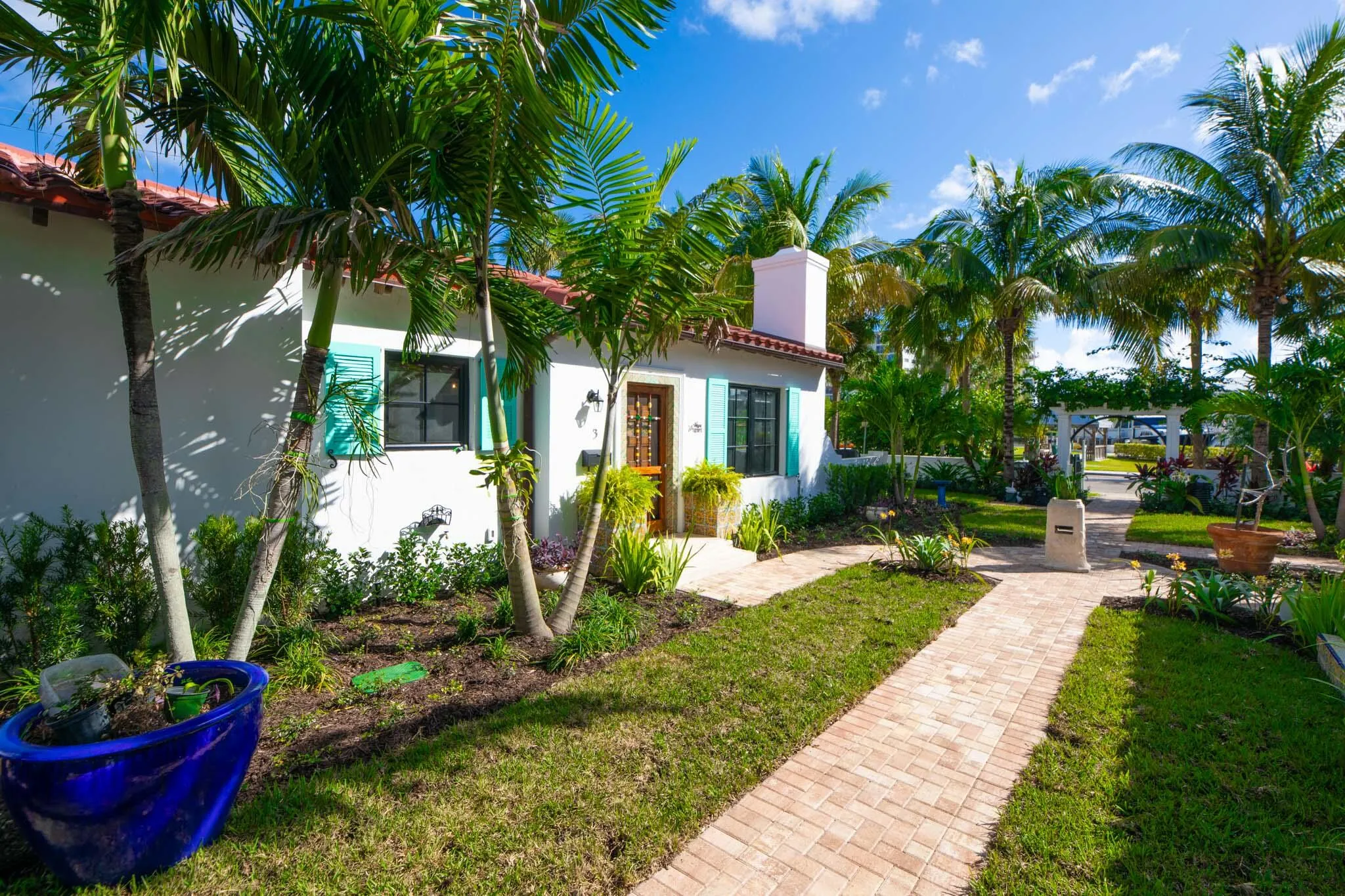 White stucco exterior with a terra cotta tile roof