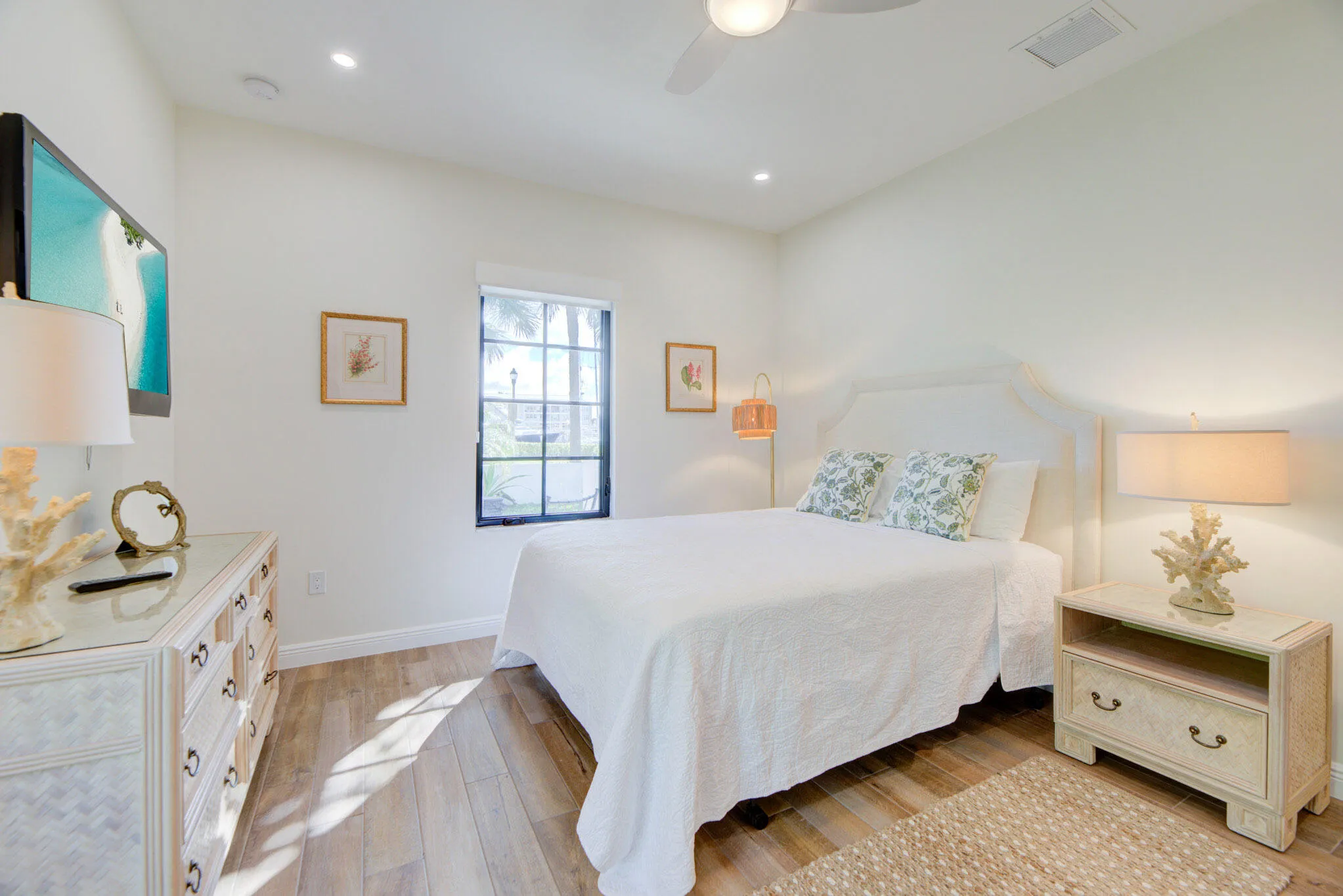 Bedroom featuring wood-finish flooring, a ceiling fan, recessed lighting, and a impact windows.