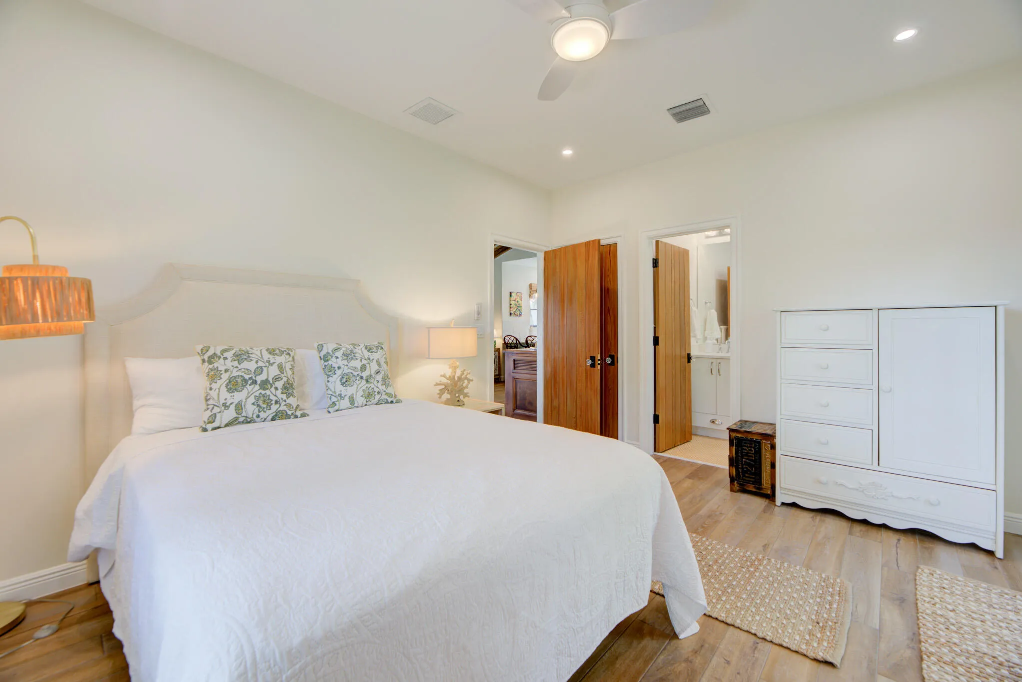 Vaulted ceiling bedroom with wood-finish flooring, recessed lighting, and a ceiling fan