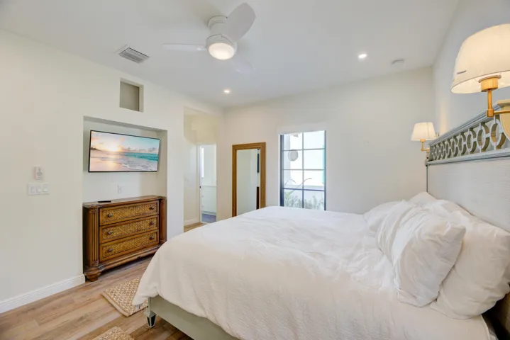 Bedroom featuring wood-finish flooring, recessed lighting, and a ceiling fan