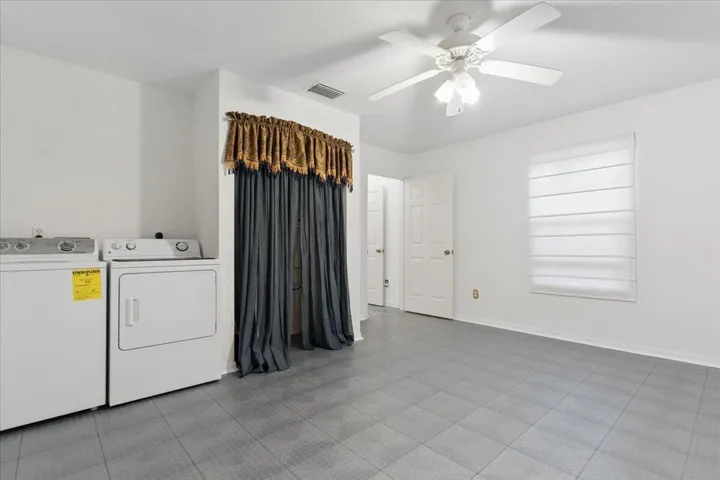 Currently used as a garage extension or for storage. Easily converted back to bedroom usage. (Additional washer/dryer hookups in porch closet.)