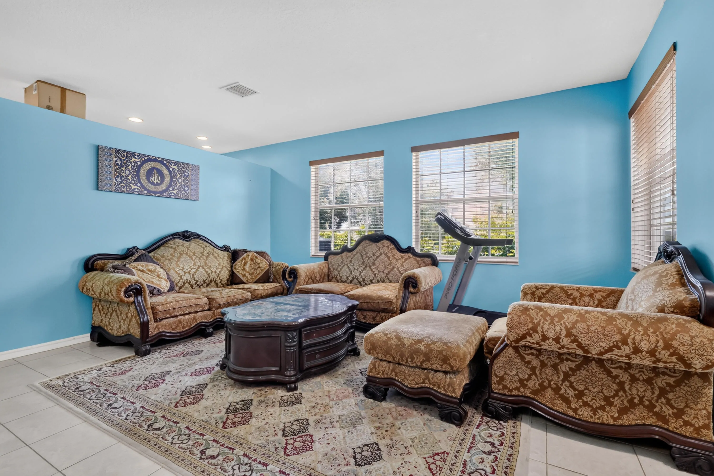 Bright interior with light blue walls and neutral tile flooring