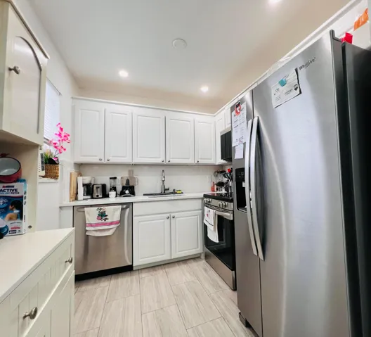 Lovely First Floor Corner 2/1.5 With Updated Kitchen, Updates to Baths, and Nice Tile Flooring