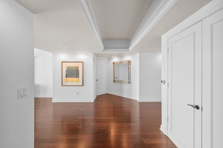 A DOUBLE DOOR ENTRANCE INTO THE FORMAL FOYER