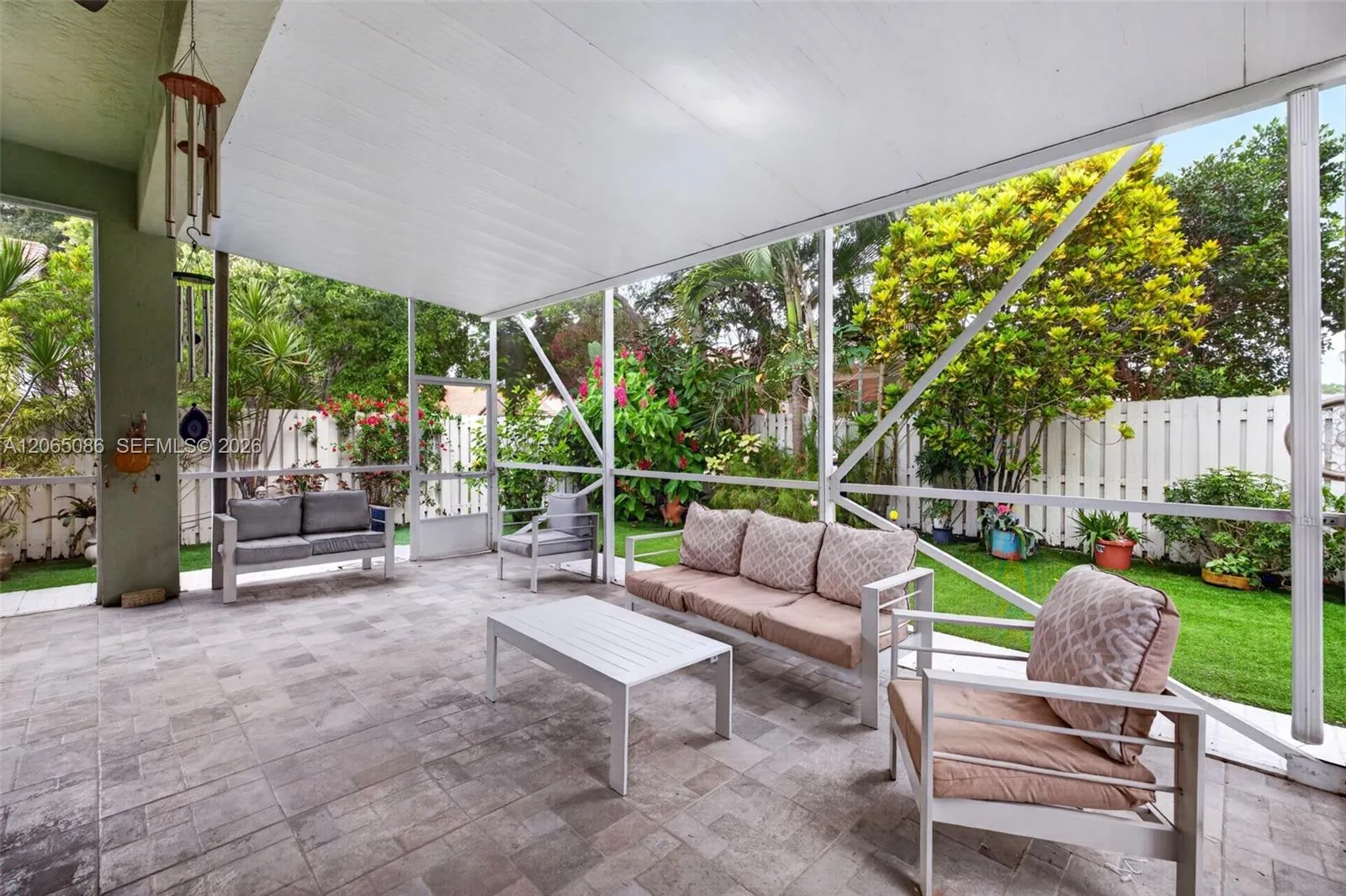 Step outside to your large, fully tiled, screened-in patio with a covered overhang overlooking a fully fenced backyard with mature fruit trees and a Rain Bird irrigation system.