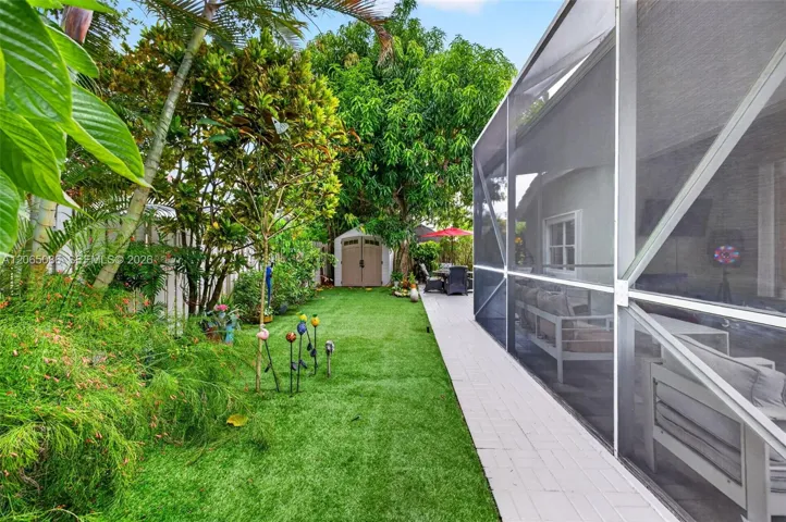 Step outside to your large, fully tiled, screened-in patio with a covered overhang overlooking a fully fenced backyard with mature fruit trees, astroturf and a Rain Bird irrigation system.