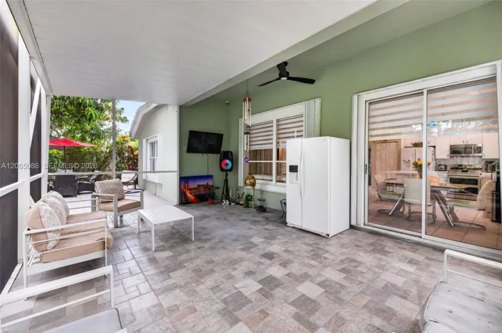 Step outside to your large, fully tiled, screened-in patio with a covered overhang overlooking a fully fenced backyard with mature fruit trees, astroturf and a Rain Bird irrigation system.