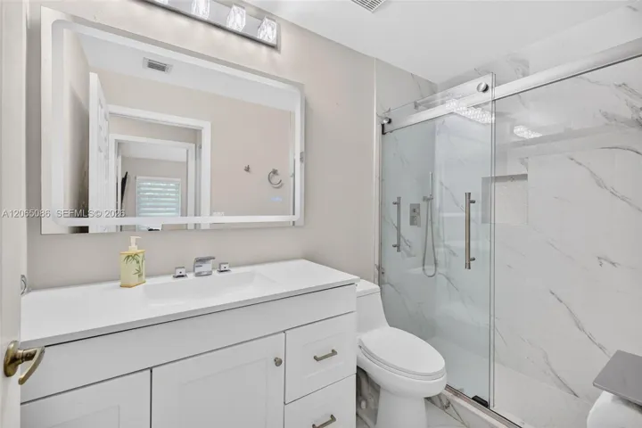 Updated Guest Bathroom w/ Glass Shower Enclosure, updated vanity and backlit mirror