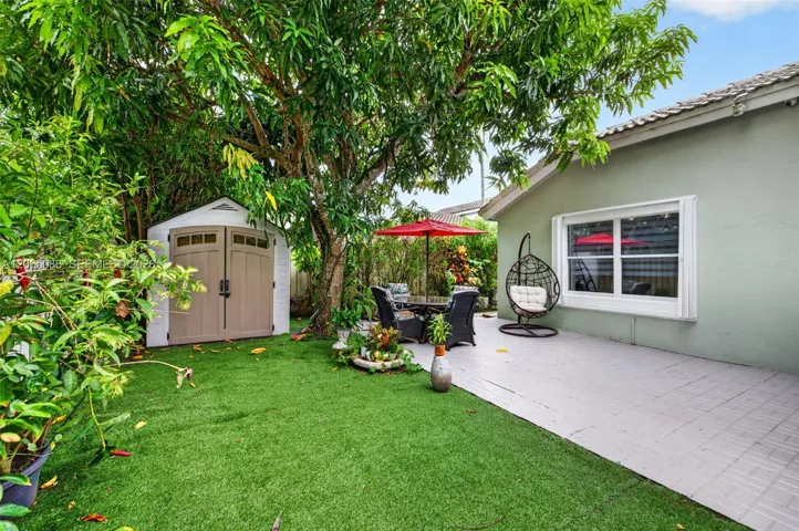 Step outside to your large, fully tiled, screened-in patio with a covered overhang overlooking a fully fenced backyard with mature fruit trees and a Rain Bird irrigation system.
