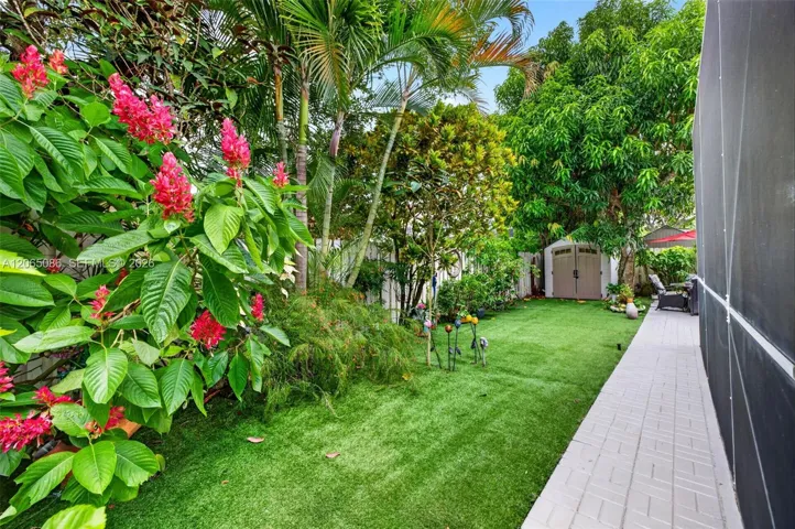 Step outside to your large, fully tiled, screened-in patio with a covered overhang overlooking a fully fenced backyard with mature fruit trees, astroturf and a Rain Bird irrigation system.