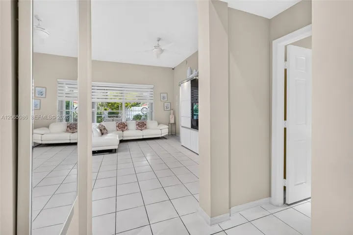 View from Living Area to Family Room. Powder room to the right.