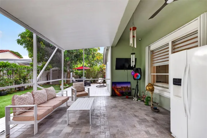 Step outside to your large, fully tiled, screened-in patio with a covered overhang overlooking a fully fenced backyard with mature fruit trees, astroturf and a Rain Bird irrigation system.