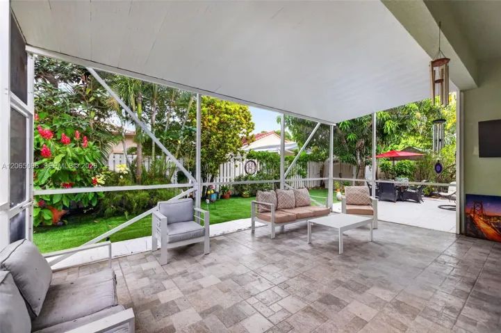 Step outside to your large, fully tiled, screened-in patio with a covered overhang overlooking a fully fenced backyard with mature fruit trees, astroturf and a Rain Bird irrigation system.
