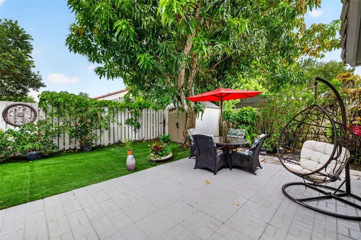 Step outside to your large, fully tiled, screened-in patio with a covered overhang overlooking a fully fenced backyard with mature fruit trees, astroturf and a Rain Bird irrigation system.