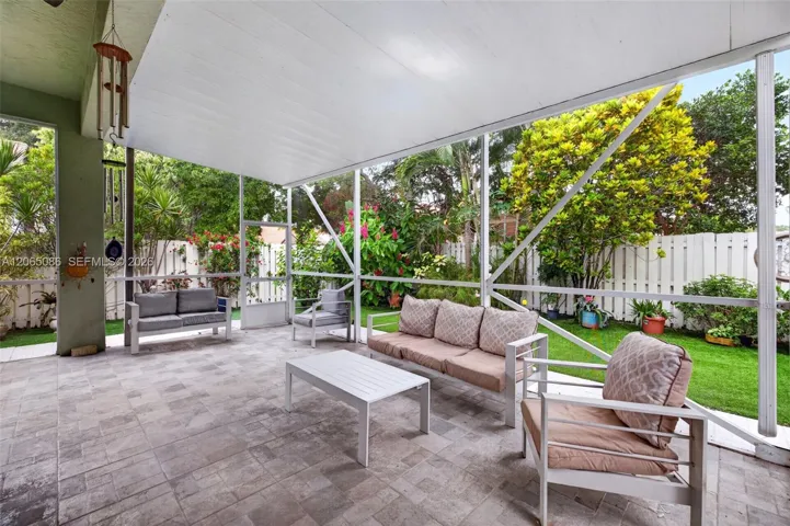 Step outside to your large, fully tiled, screened-in patio with a covered overhang overlooking a fully fenced backyard with mature fruit trees and a Rain Bird irrigation system.
