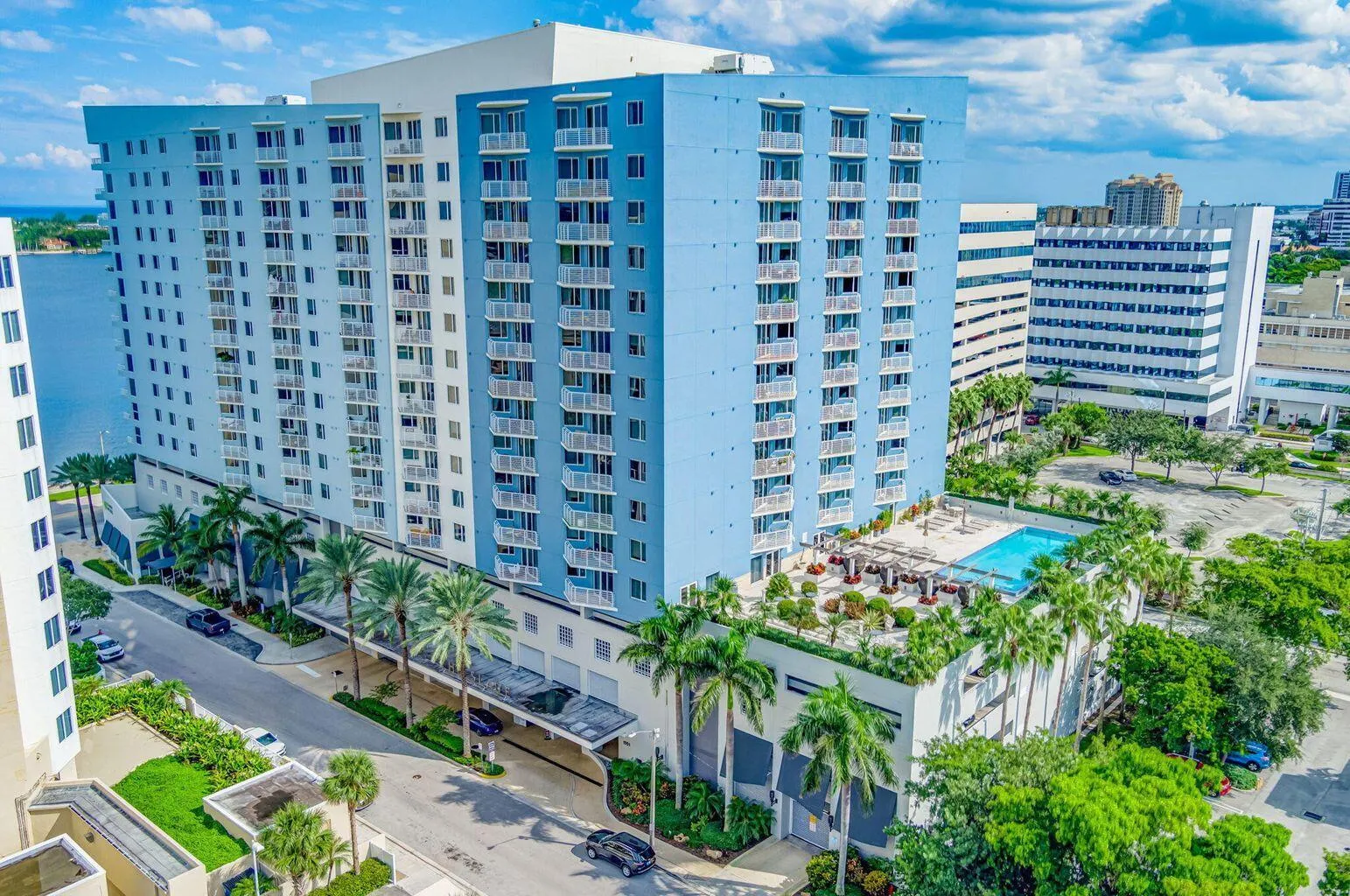 Multi-story residential tower featuring a light blue and white facade
