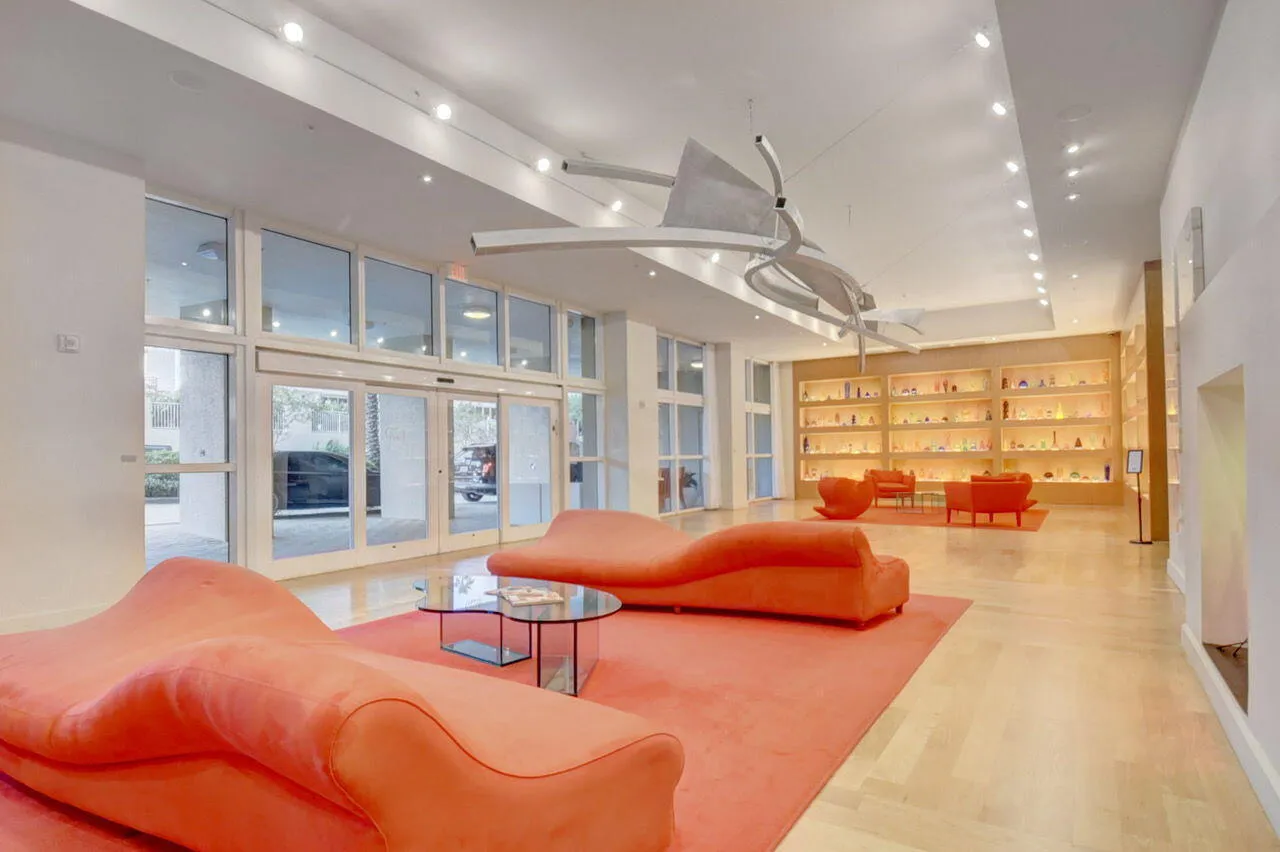 Spacious lobby area featuring light wood-finish flooring, recessed lighting, and a modern ceiling fixture