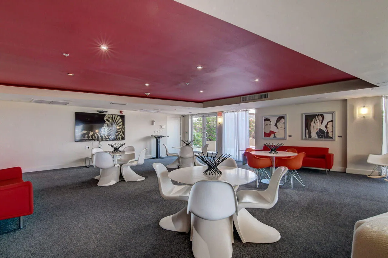 Spacious common area featuring recessed lighting, a media wall, and carpet flooring