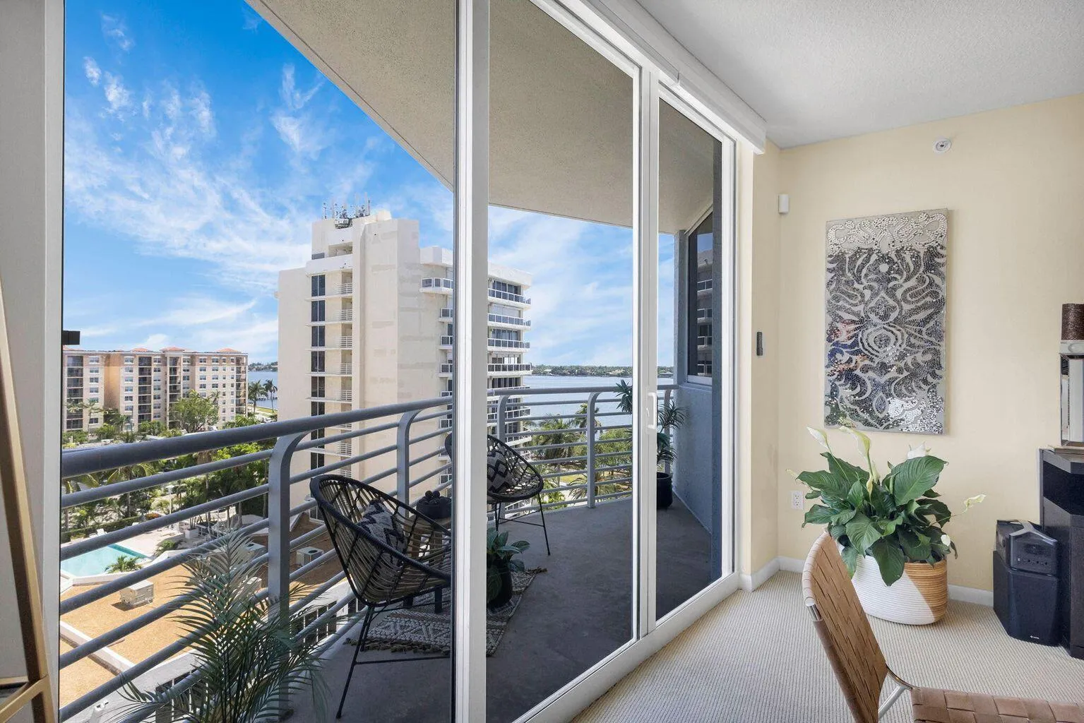 Sliding glass doors open to a private balcony featuring metal railings