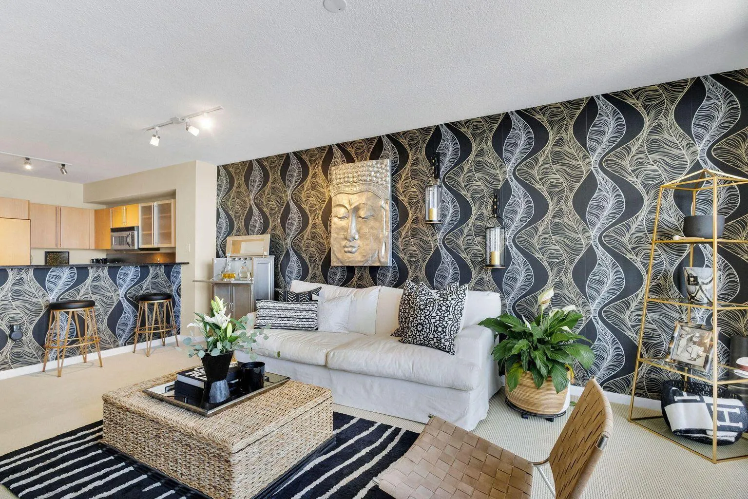 Open-concept living area featuring a patterned accent wall, recessed lighting, and track lighting