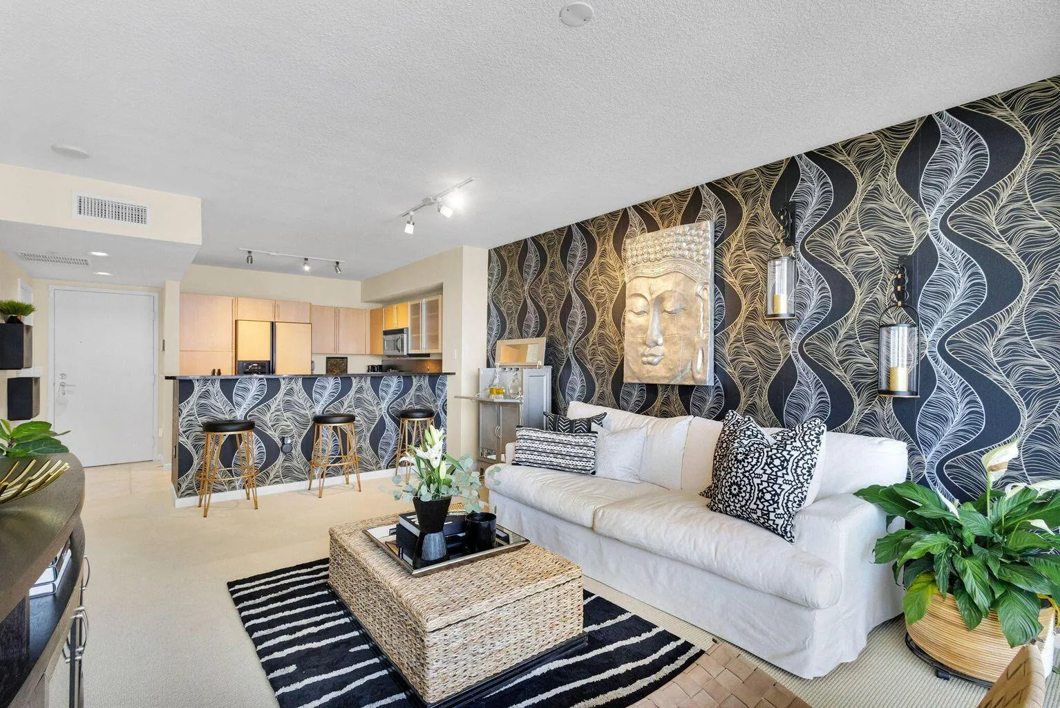 Open-concept living space featuring a custom accent wall, recessed lighting, and a breakfast bar with built-in cabinetry