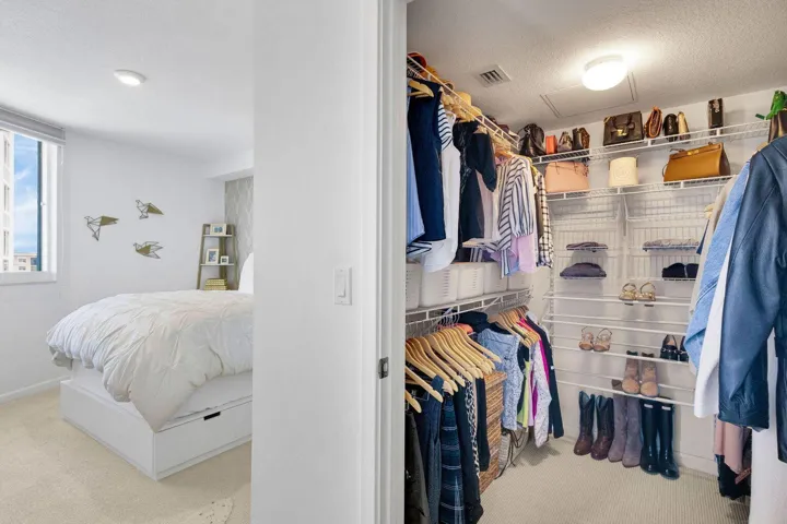 Expansive walk-in closet featuring floor-to-ceiling wire shelving and ample hanging space