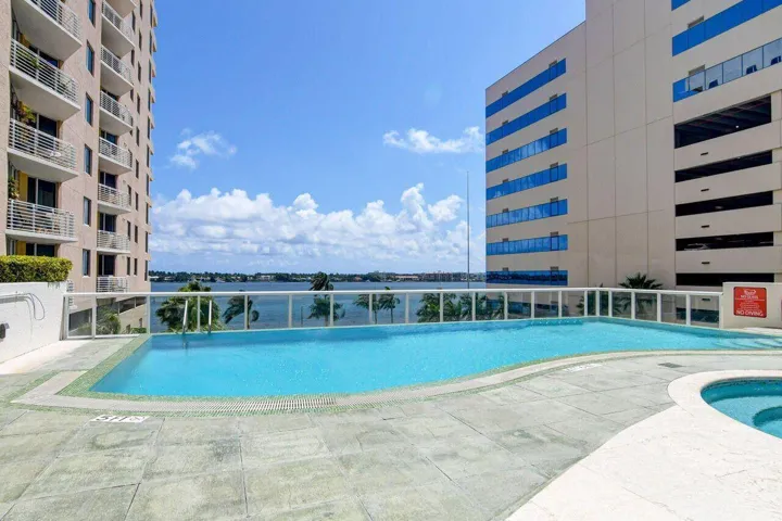Outdoor swimming pool featuring a curved design and integrated spa