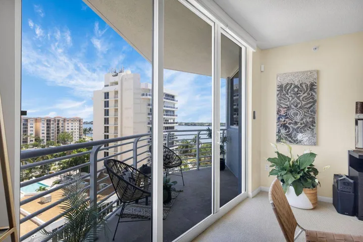 Sliding glass doors open to a private balcony featuring metal railings