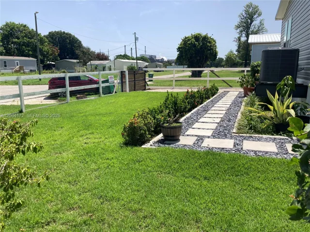 The front yard and driveway is fenced and gated