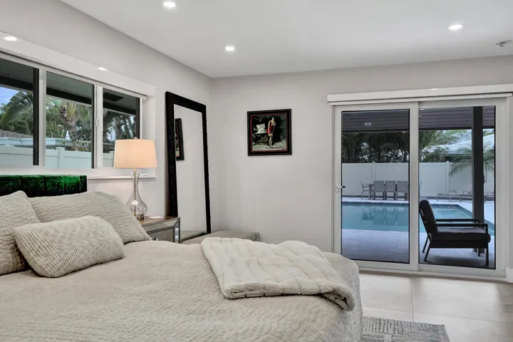 Master bedroom with views of pool