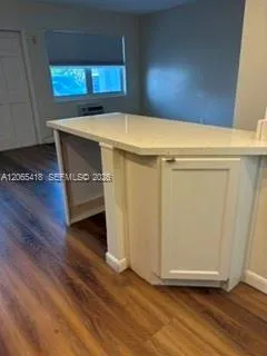 Breakfast bar with quartz countertops and storage below