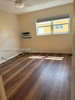 Nice size bedroom with wood laminate flooring