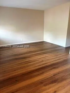 Living room with wood laminate flooring.