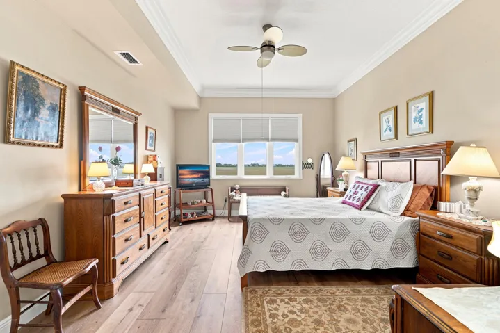 Spacious primary bedroom has ensuite bath and two walk-in closets.
