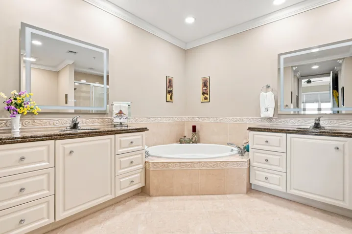 Primary bath has double vanities, a deep soaking tub, and a separate shower. Also included is a new Fan, LED Mirror with Backlit + Frontlit, Anti-Fog Tempered Glass, and New LED Ceiling Lights.