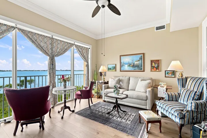 Sunroom is bright and cheery...a perfect spot to relax. All windows and doors are impact rated and these sliders are screened so you can open the doors and let the breeze blow through.