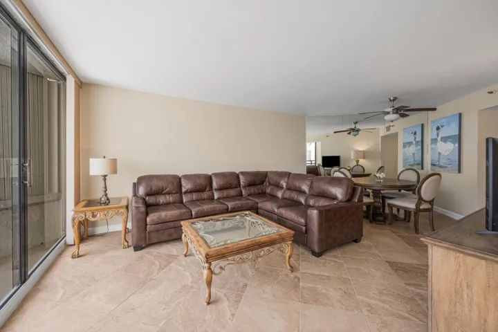 Spacious living area featuring large format tile flooring and neutral wall tones