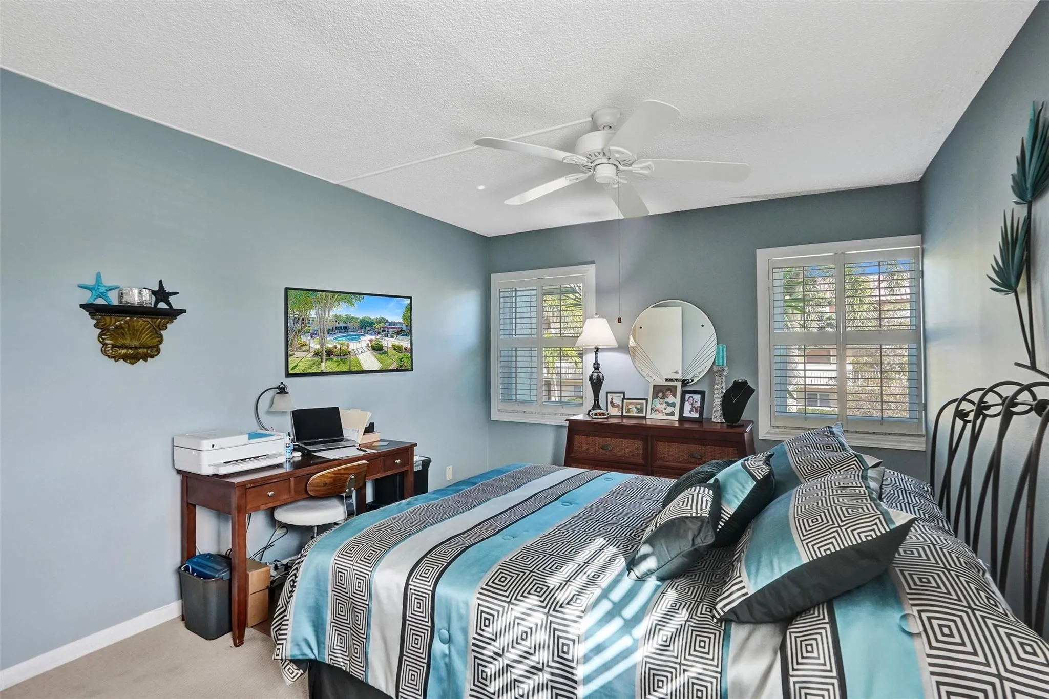 Plenty of natural bright light in this primary bedroom with 3 impact windows.