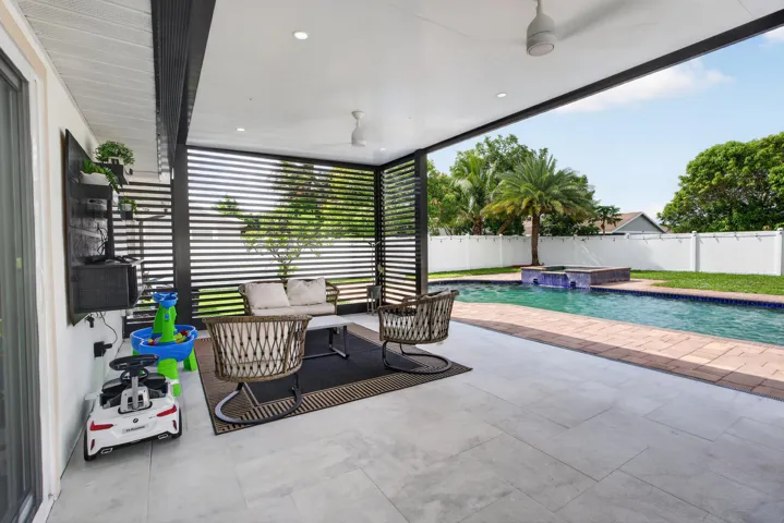Covered patio featuring recessed lighting and ceiling fans