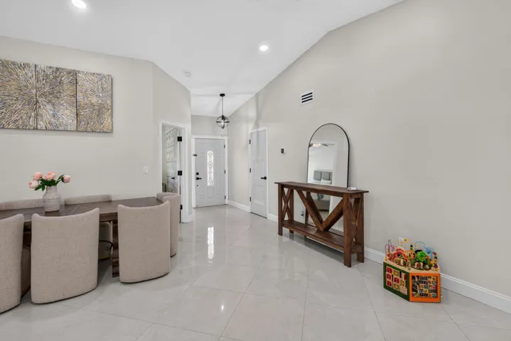 Spacious interior with vaulted ceilings and recessed lighting