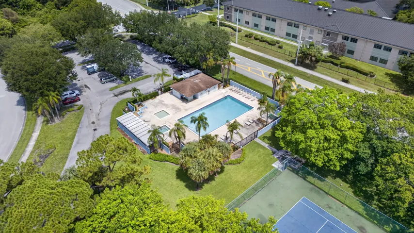 Community pool and spa area featuring a surrounding patio with lounge chairs