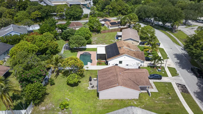 Aerial perspective showcasing multiple properties with mature landscaping