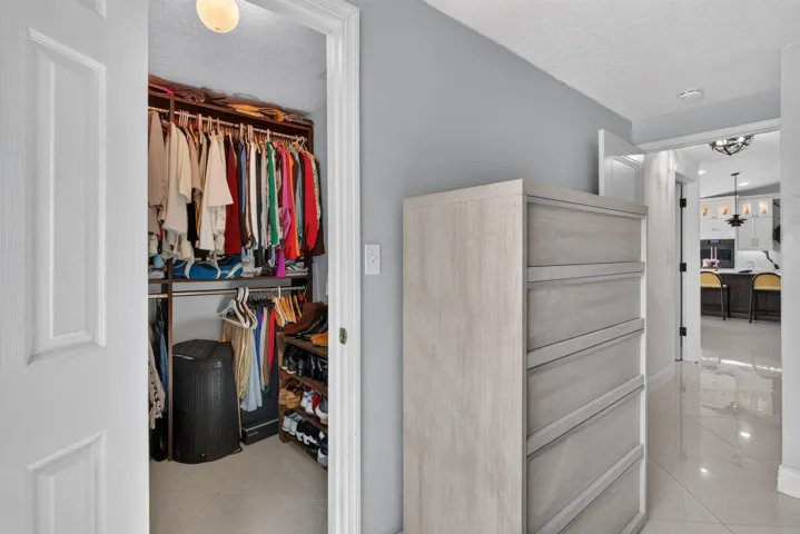 Walk-in closet with built-in shelving and hanging rods